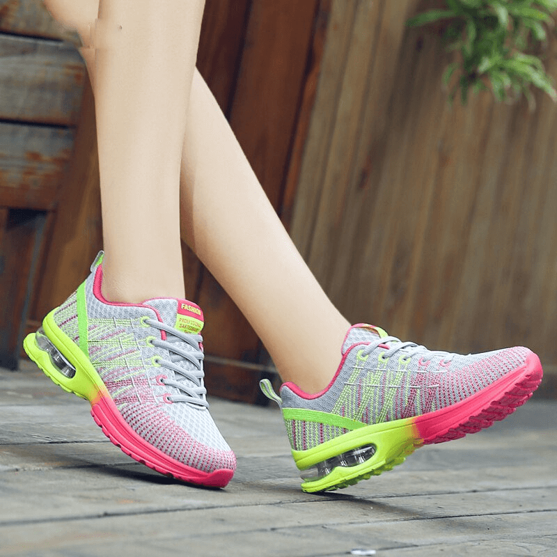 Bright mesh women's sneakers with pink and green accents, featuring breathable material and lightweight EVA soles for active comfort.